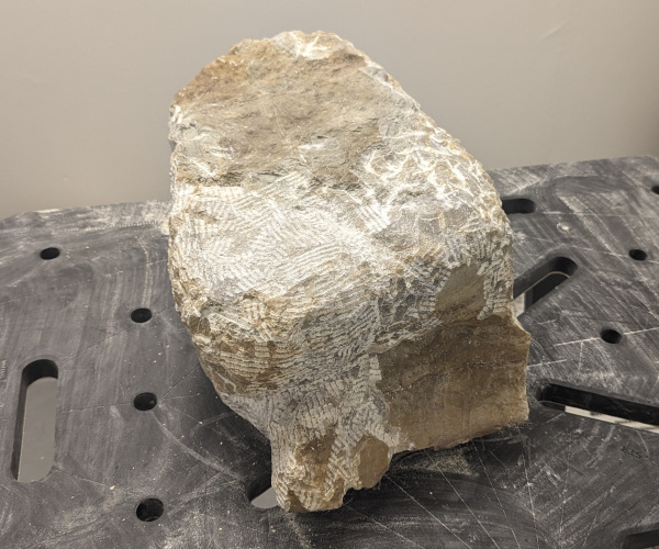 an abstract sculpture made from alabaster. it resembles a heart and a butt