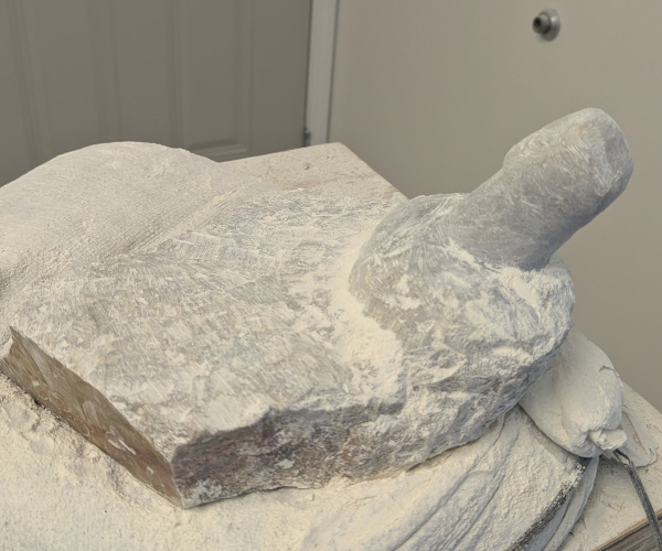 a sculpture made from alabaster featuring an erect penis