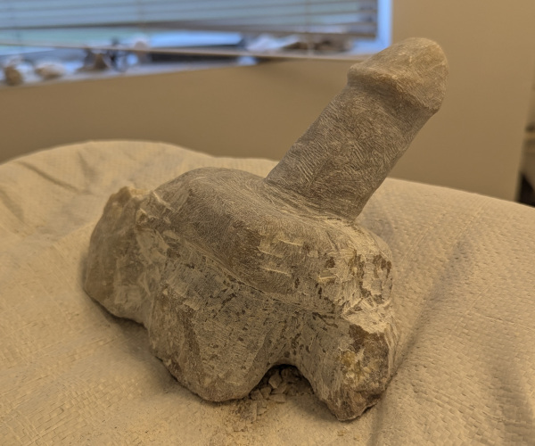 a sculpture made from alabaster featuring an erect penis