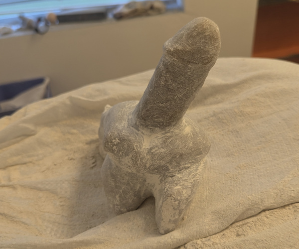 a sculpture made from alabaster featuring an erect penis