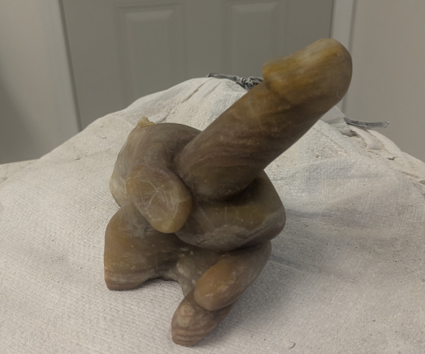 a sculpture made from alabaster featuring an erect penis