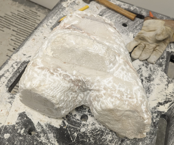 a sculpture made from marble showing a nude male figure